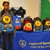 The Miles family receiving their new backpack from the LGW at the Oliver St. School in Newark.