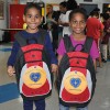Two kids from the YMCA Shelter of Newark with their new backpacks from the LGW